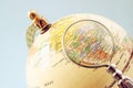 Close up of old vintage globe and magnifying glass Royalty Free Stock Photo