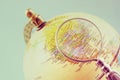 Close up of old vintage globe and magnifying glass. Royalty Free Stock Photo