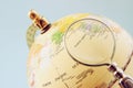 Close up of old vintage globe and magnifying glass Royalty Free Stock Photo