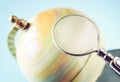 Close up of old vintage globe and magnifying glass Royalty Free Stock Photo