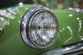 Close up old vintage green car headlight chrome Royalty Free Stock Photo