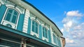 Close up of old vintage windows and roof Asian building in Sino Portuguese architecture style with beautiful blue sky and white cl Royalty Free Stock Photo