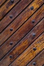 Close up of old vintage wooden door with metal furniture.  Brown wooden fence background texture Royalty Free Stock Photo