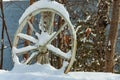 Antique wagon wheel on snow, close-up Royalty Free Stock Photo