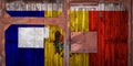 Close-up of old warehouse gate with national flag