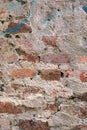 Close-up of an old, weathered, and chipped brick wall texture with visible pink, red, and white mortar Royalty Free Stock Photo