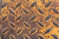 Rusty industrial metal plate with diamond pattern and yellow paint Royalty Free Stock Photo