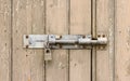 Wooden door with flaking paint with locked padlock. UK Royalty Free Stock Photo