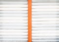 Old white and orange rolling steel door texture for background Royalty Free Stock Photo