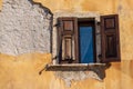 Window with wooden shutters and broken wall - Trentino Italy Royalty Free Stock Photo