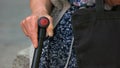 Close up old woman hand holding walking stick. Royalty Free Stock Photo