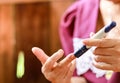 Close up of old woman hands using lancet on finger to check blood sugar level by Glucose meter. Use as Medicine, diabetes, Royalty Free Stock Photo