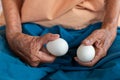 Close-up of the old woman's hand Poor Thai grandmother holds a large white duck egg for dinner. Pure egg whites Royalty Free Stock Photo