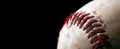 Close up of old worn baseball showing dirty red stitches. Blank space for text Royalty Free Stock Photo