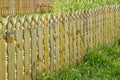 Close-up of an old yellow wooden fence. Wood fencing. Royalty Free Stock Photo