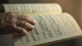 close-up of an older man\'s hand caressing a classical music sheet Royalty Free Stock Photo