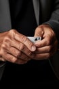 Close-up of an older man\'s hands holding an ace card. The concept of play and dispute in life