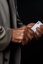 Close-up of an older man\'s hands holding an ace card. The concept of play and dispute in life