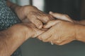 Close up older spouses holding hands with love and care, loving caring mature man comforting old senior wife, family expressing