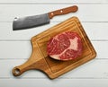 Close up raw beef ribeye steak on cutting board Royalty Free Stock Photo