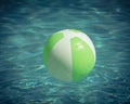 Close-up one bright green beach ball in swimming pool sunny day Royalty Free Stock Photo