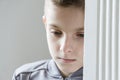 Close up of one depressed child in gray jacket