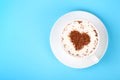Full white cup of cappuccino coffee on blue Royalty Free Stock Photo
