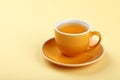 Yellow cup of green oolong tea on saucer Royalty Free Stock Photo