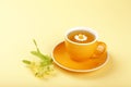 Yellow cup of herbal tea with camomile Royalty Free Stock Photo