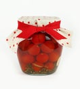 Jar of pickled small red cherry tomatoes on white Royalty Free Stock Photo