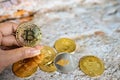 Close up one golden coin with the bitcoin symbol in hand. Young hand holding cryptocurrency coin