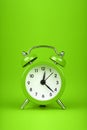 Close up one green alarm clock over green background Royalty Free Stock Photo