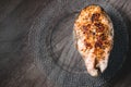 Close-up one grilled cum salmon keta fish steak on a glass transparent plate on a dark wood table background. A little Royalty Free Stock Photo