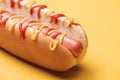 Close up of one hot dog with sausage, mustard and ketchup on yellow. Royalty Free Stock Photo