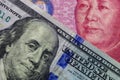 Close up of one hundred Dollar banknote over a 100 Yuan banknote with focus on portraits of Benjamin Franklin and Mao Tse-tung/USA