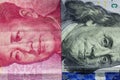 Close up of one hundred Dollar and 100 Yaun banknotes with focus on portraits of Benjamin Franklin and Mao Tse-tung/USA vs China t