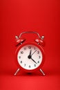 Close up one red alarm clock over red background Royalty Free Stock Photo