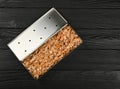 Metal smoker box with wood chips on table Royalty Free Stock Photo