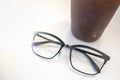 Close up oof readding glasses with plastic cup of iced black coffee on white table Royalty Free Stock Photo