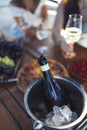 Close up of an open black bottle of champagne lying in ice cooler Royalty Free Stock Photo