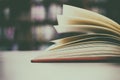 Close up of open book on desk with vintage filter blur background Royalty Free Stock Photo