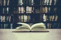 Close up of open book on desk with vintage filter blur background Royalty Free Stock Photo