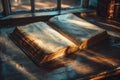 Closeup of an open book on a vintage library table sunlight highlighting the text Royalty Free Stock Photo