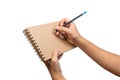 Close up of open brown blank notebook with ring loop binding. Empty wire-o brown notebook holding hand and pencil for business and