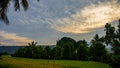 Beautiful view of the sunrise sky when the weather is cloudy in the rice fields Royalty Free Stock Photo