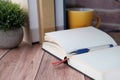 Close up of open diary, pen and books on table. Royalty Free Stock Photo