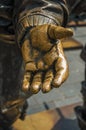 Close-up of open hand in bronze sculpture on the Rembrandt Square in a sunny day at Amsterdam.