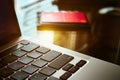 Close-up of an open laptop, a credit bank card and a large cup of coffee on a glass table in the morning in the kitchen Royalty Free Stock Photo