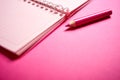 Close up of open notebook and pencil on blurred pink desk Royalty Free Stock Photo