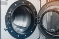 Close-up of an open shiny dryer. High-quality photo of drying drum in dry cleaner. View from inside